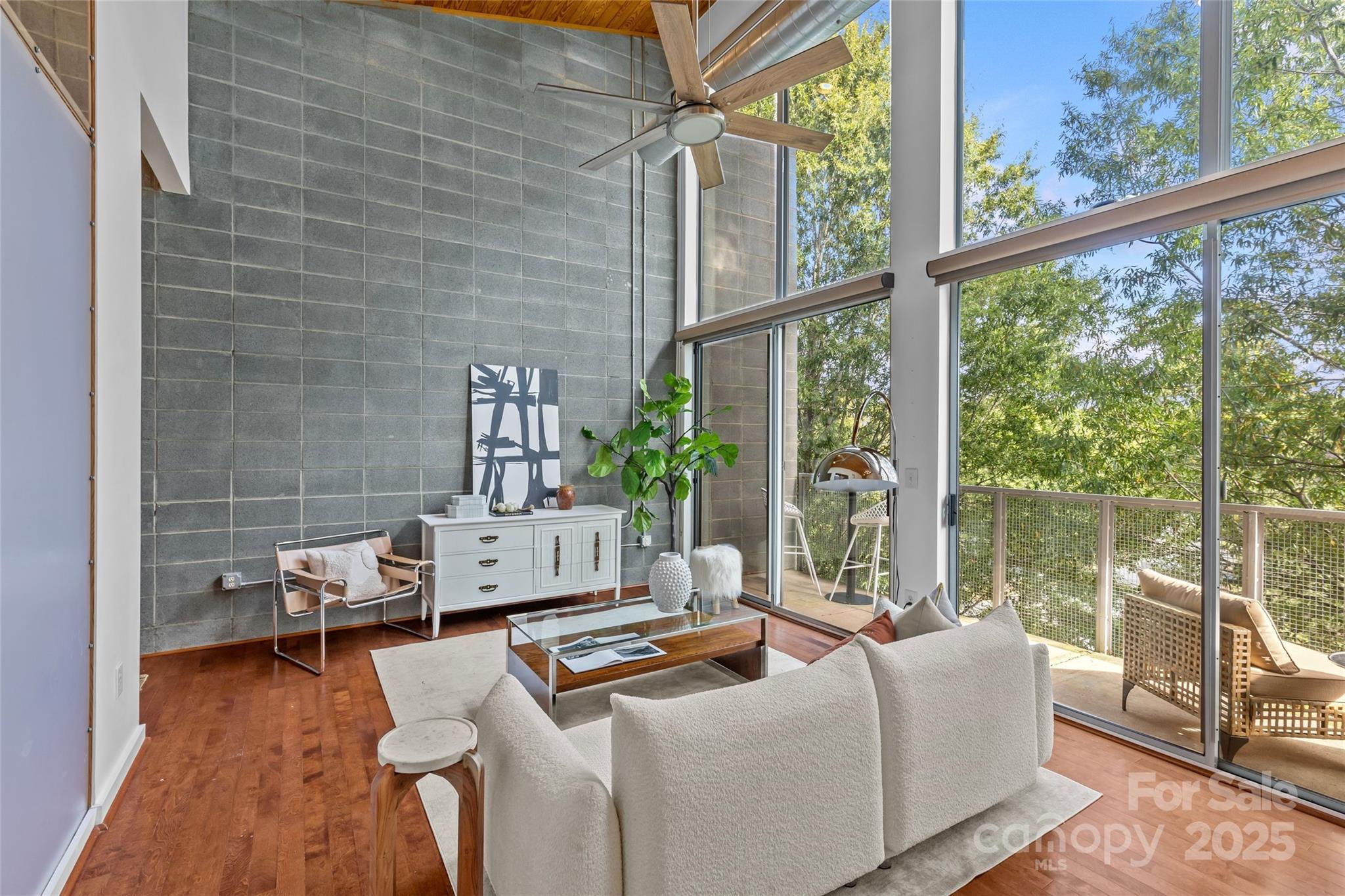 2116 McClintock Road, Unit 232 Charlotte, NC 28205 - Photo 10 of 48 a living room with furniture and a floor to ceiling window