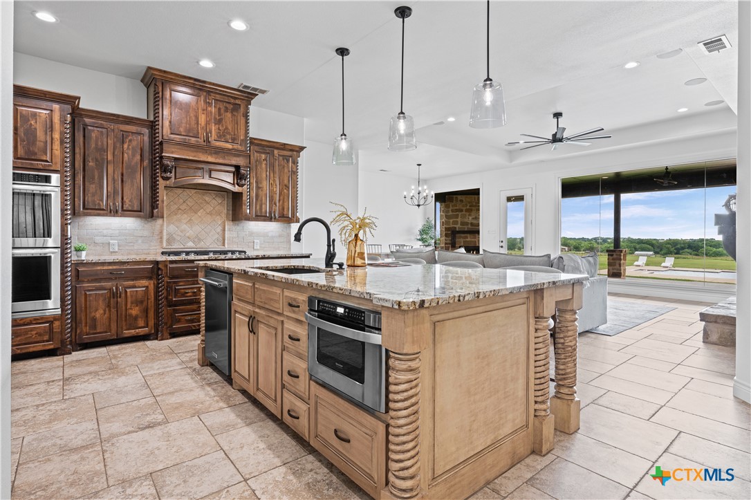 11023 Bigham Road Troy, TX 76579 - Photo 11 of 42 a kitchen with stainless steel appliances granite countertop a stove and a sink