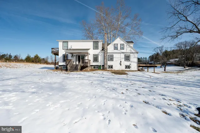 a bathroom with a toilet a sink and shower
