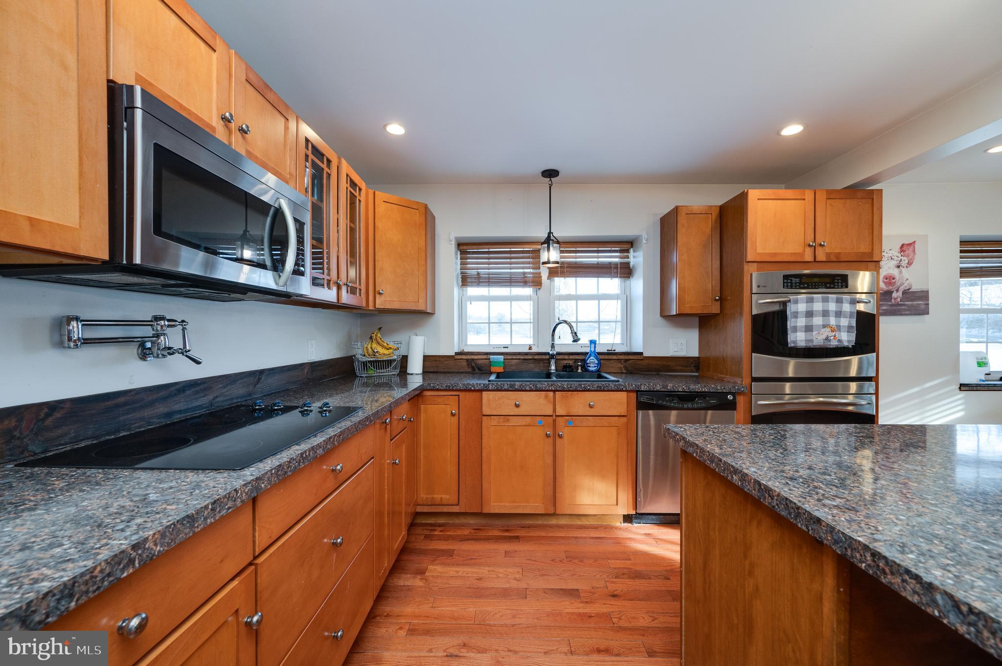 1109 Upper Van Reed Road Leesport, PA 19533 - Photo 32 of 72 a kitchen with stainless steel appliances granite countertop a stove a sink and a microwave