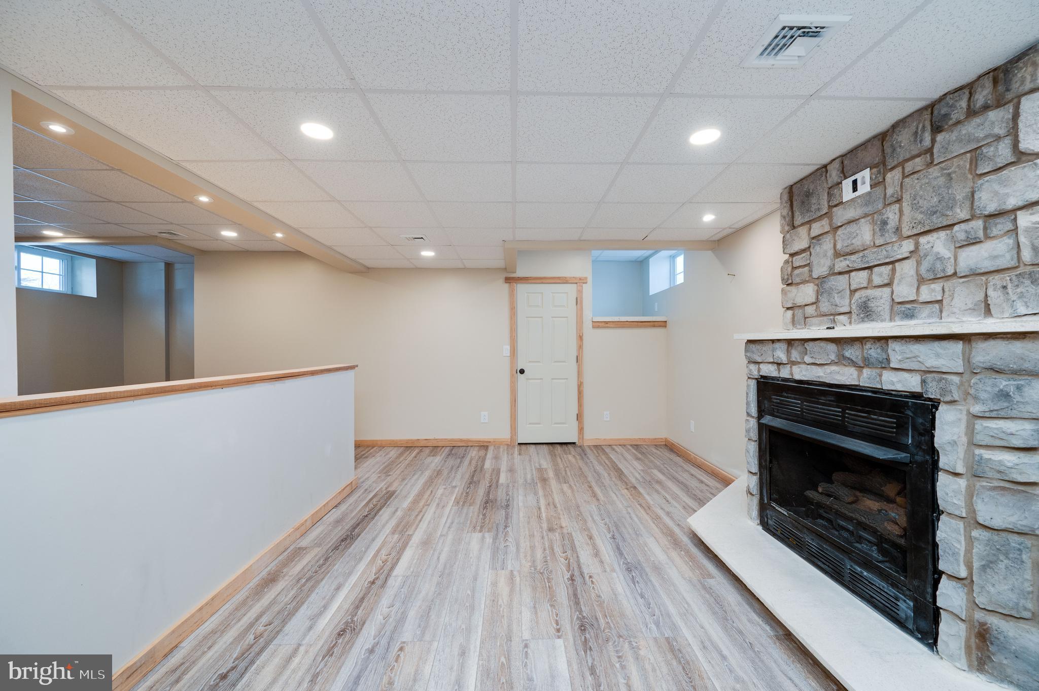 1109 Upper Van Reed Road Leesport, PA 19533 - Photo 64 of 72 a view of an empty room with wooden floor fire place and a window