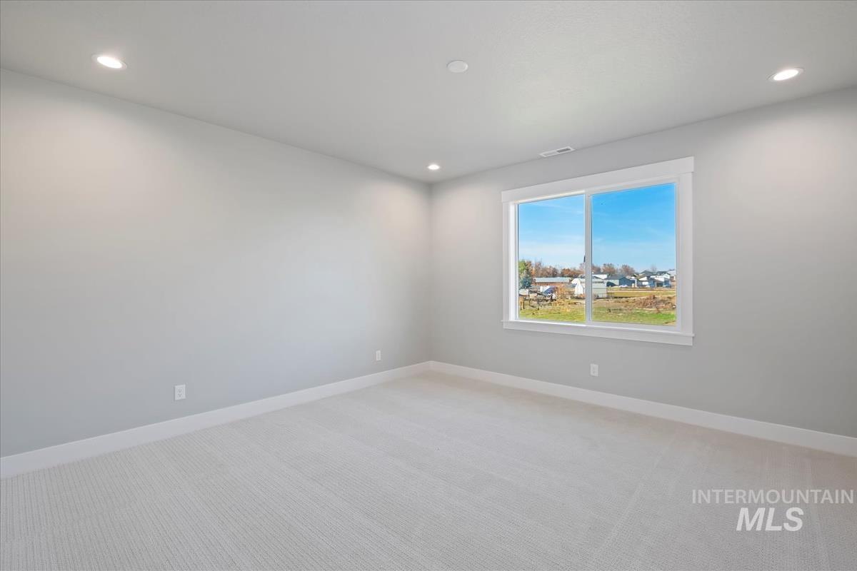 404 Hidden Mill Middleton, ID 83644 - Photo 32 of 41 Unfurnished room featuring light carpet and recessed lighting