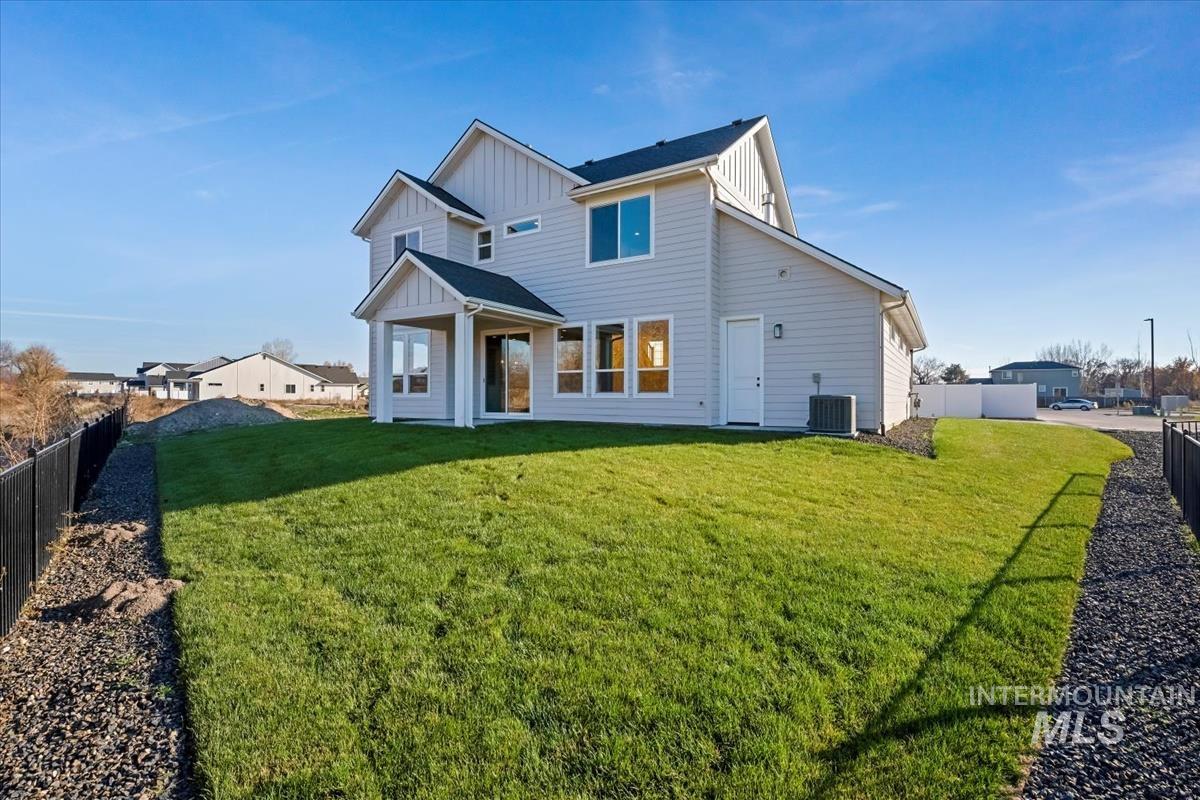 404 Hidden Mill Middleton, ID 83644 - Photo 36 of 41 Back of property featuring board and batten siding, a fenced backyard, and a patio