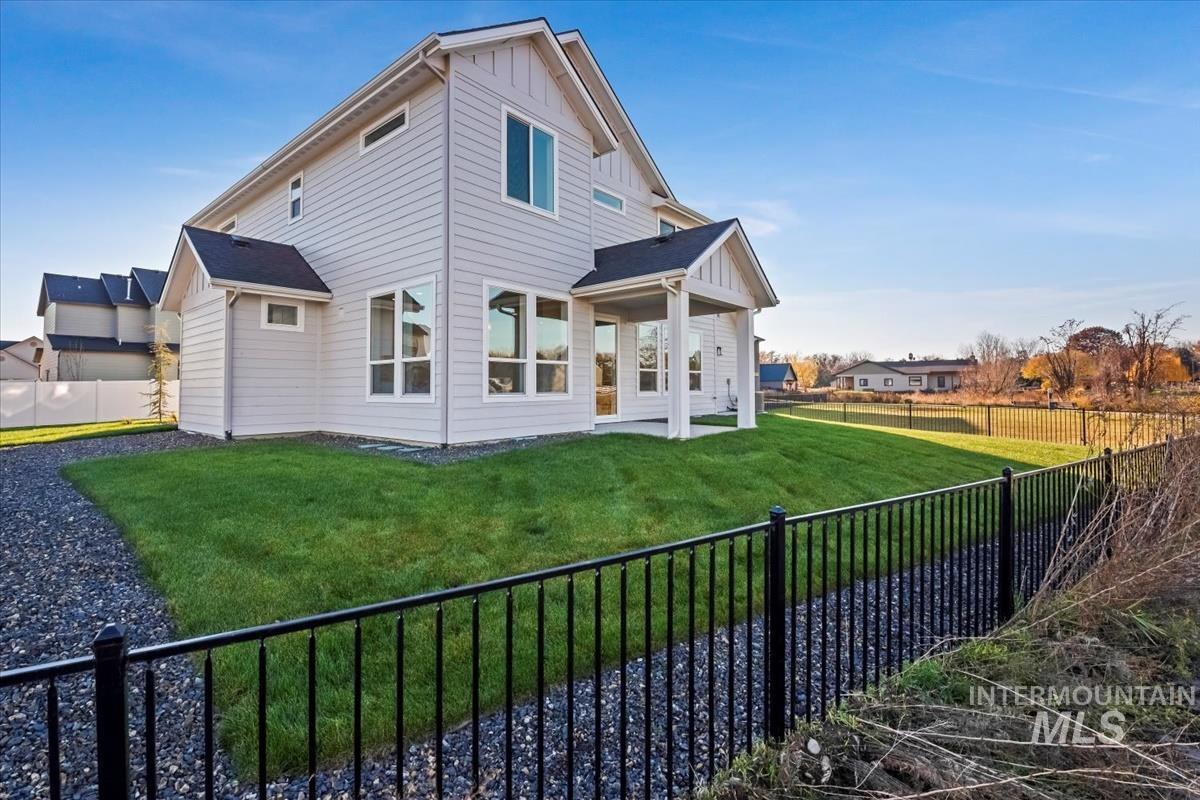 404 Hidden Mill Middleton, ID 83644 - Photo 38 of 41 Back of property featuring a fenced backyard, a patio, and board and batten siding