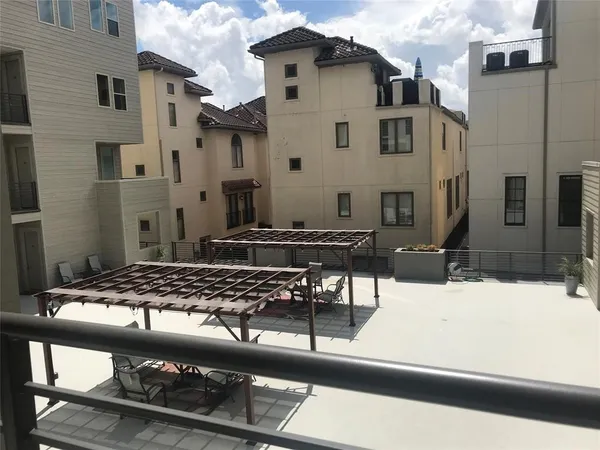 a view of a patio with chair and tables