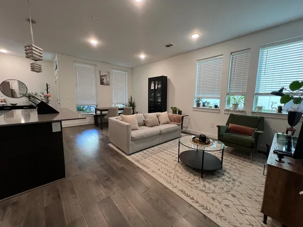 a living room with furniture and a potted plant