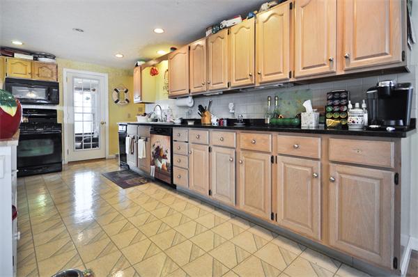 18 Olympia Road Marshfield, MA 02050 - Photo 9 of 30 a kitchen with stainless steel appliances granite countertop a refrigerator sink and cabinets