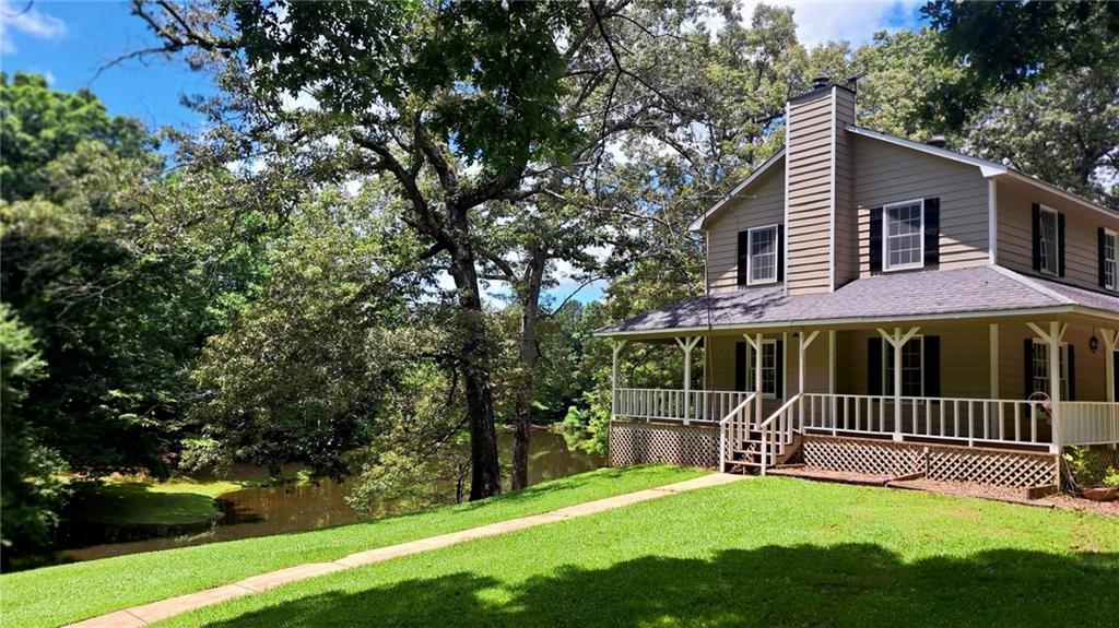 112 Brannon Road Buchanan, GA 30113 - Photo 2 of 40 a view of a house with a yard and a large tree