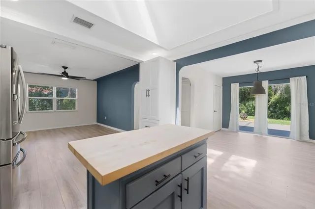a kitchen with a stove and a wooden cabinets