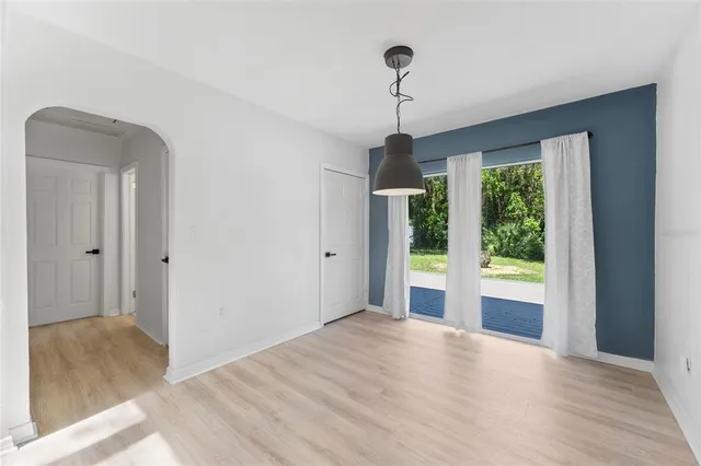 a view of empty room with window and outdoor view