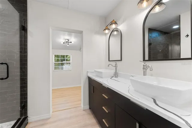 a bathroom with a double vanity sink and a mirror