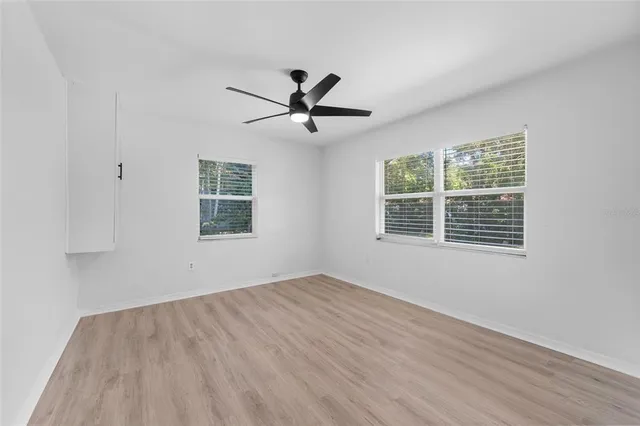 a view of a livingroom with a ceiling fan and window