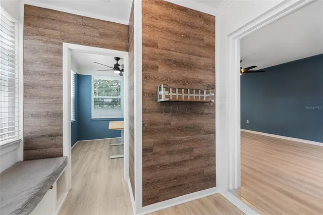 a view of a hallway with wooden floor and entryway