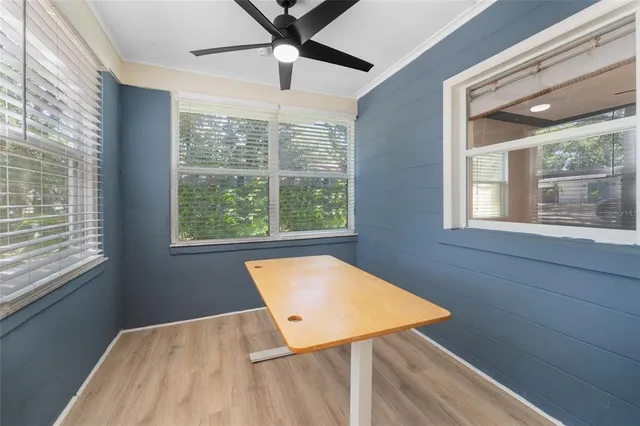 a view of a room that has a window and wooden floor