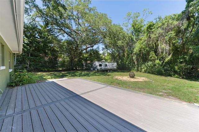 a view of a backyard with a wooden deck