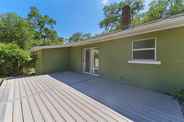 a view of a house with a wooden deck