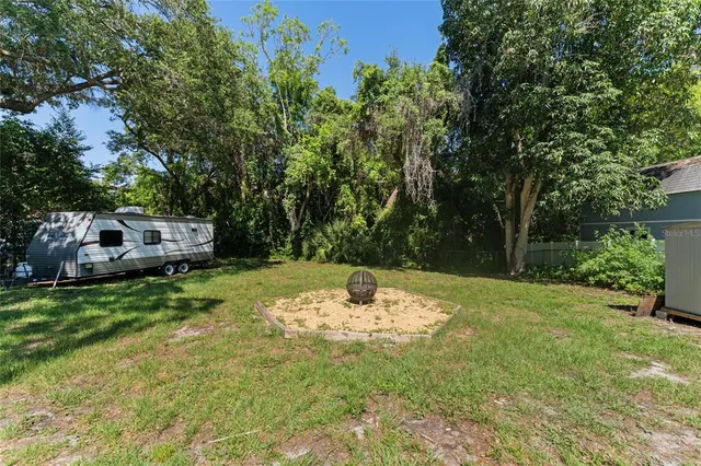 a backyard of a house with yard and trampoline
