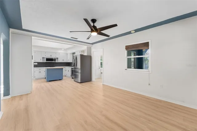 a view of a kitchen with a sink and a refrigerator
