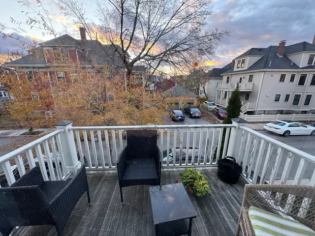 a view of balcony with wooden floor and outdoor seating