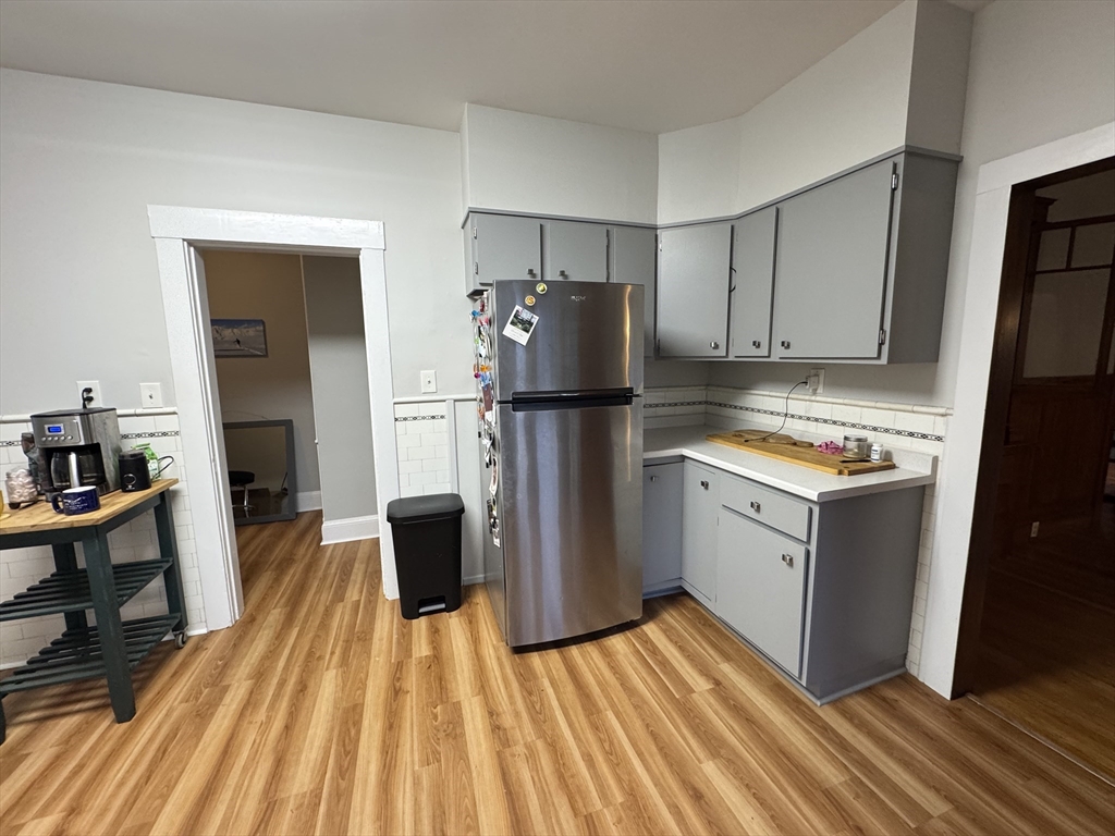 10-12 Ashcroft Street, Unit 2 Boston, MA 02130 - Photo 4 of 12 a kitchen with a refrigerator and wooden floor