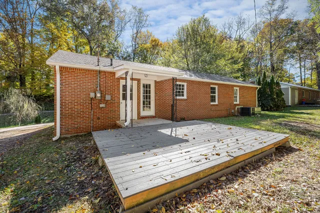 a view of a wooden house with a yard