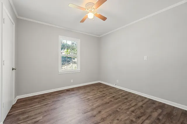 wooden floor in an empty room with a window