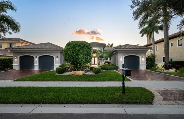 a front view of a house with a garden and plants