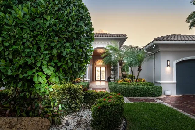 a view of a patio with couches table and chairs with wooden floor and fence