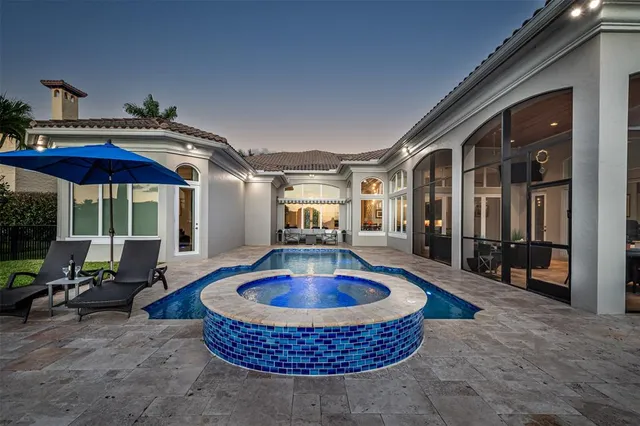 a view of a house with a yard and large tree