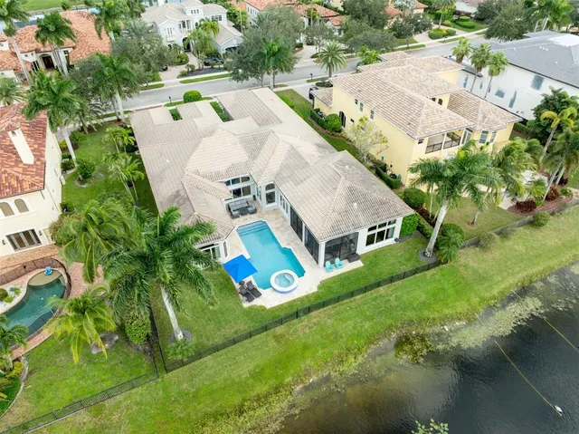 a large bathroom with a granite countertop sink a mirror and a bathtub