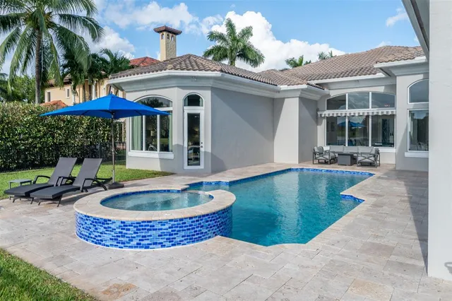 a bathroom with a granite countertop sink a toilet a shower and a mirror