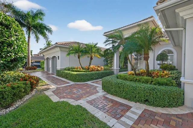 a bathroom with a granite countertop toilet sink and mirror