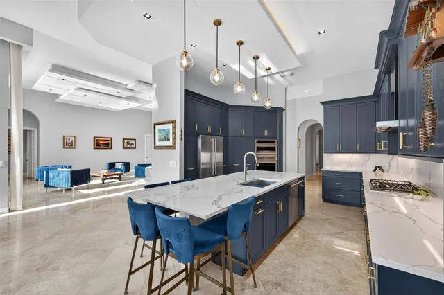 a large kitchen with a table and chairs