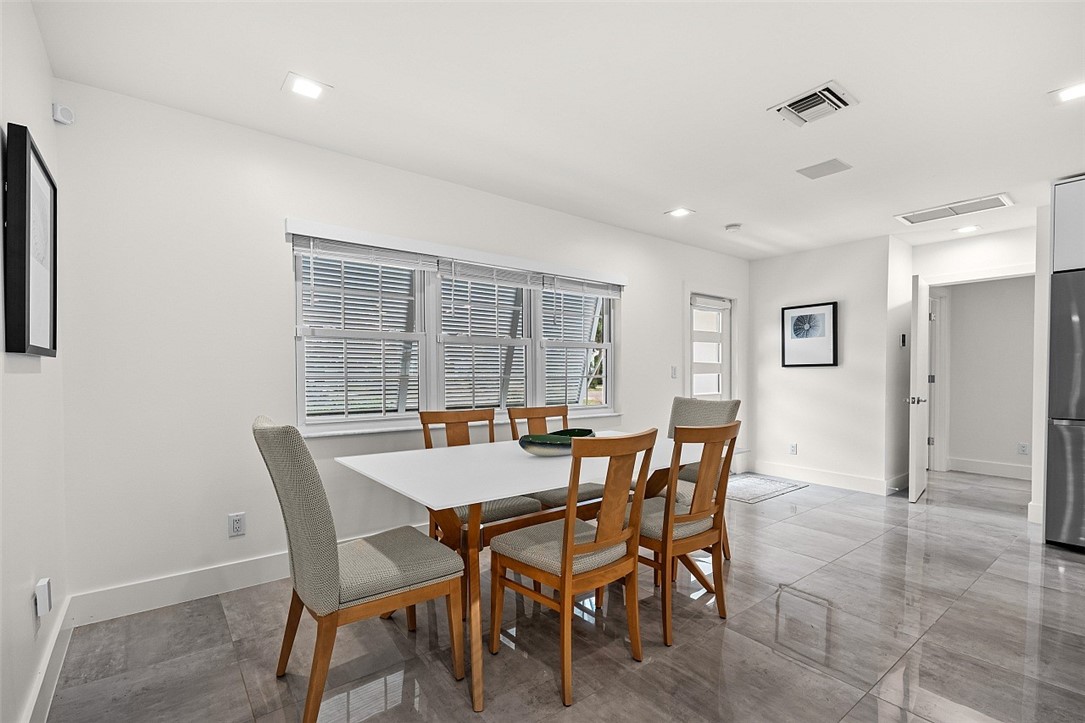 774 Azalea Lane Vero Beach, FL 32963 - Photo 13 of 34 a view of a dining room with furniture and a large window