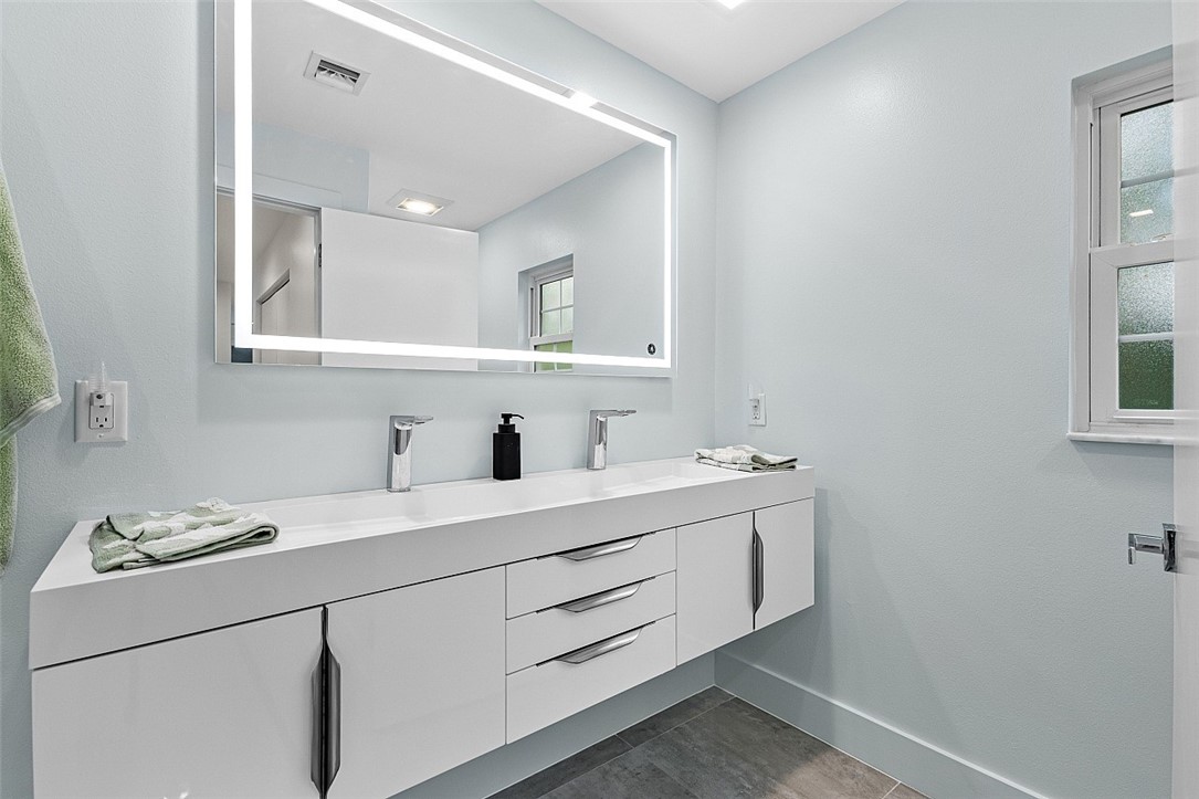 774 Azalea Lane Vero Beach, FL 32963 - Photo 22 of 34 a bathroom with a sink and a mirror