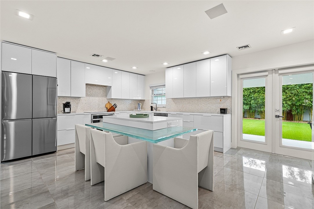 774 Azalea Lane Vero Beach, FL 32963 - Photo 10 of 34 a kitchen that has a lot of cabinets in it and appliances