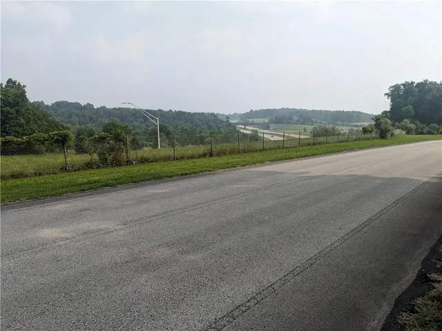 a view of a field with an ocean view