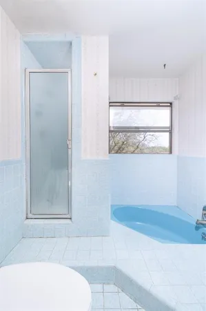 a bathroom with a bathtub and a shower