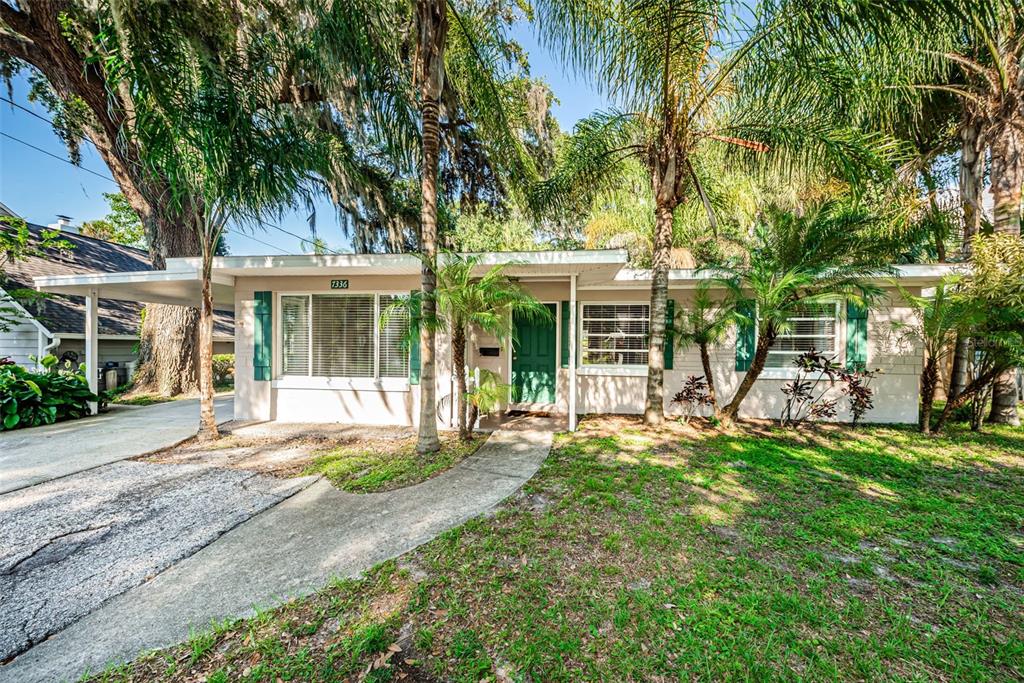 7336 Astor Drive New Port Richey, FL 34652 - Photo 1 of 1 front view of a house with a big yard and large trees