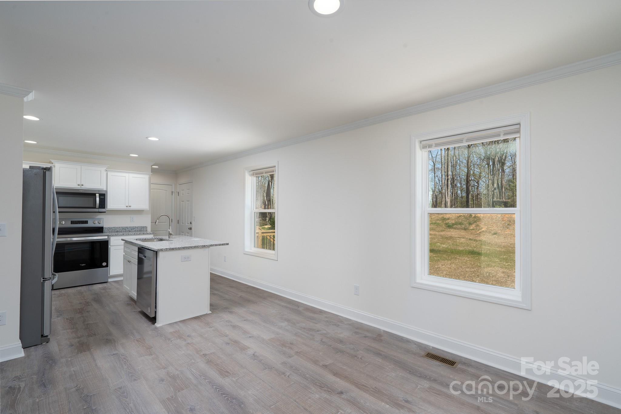 6205 Faith Road Salisbury, NC 28146 - Photo 11 of 33 a kitchen with white cabinets and appliances