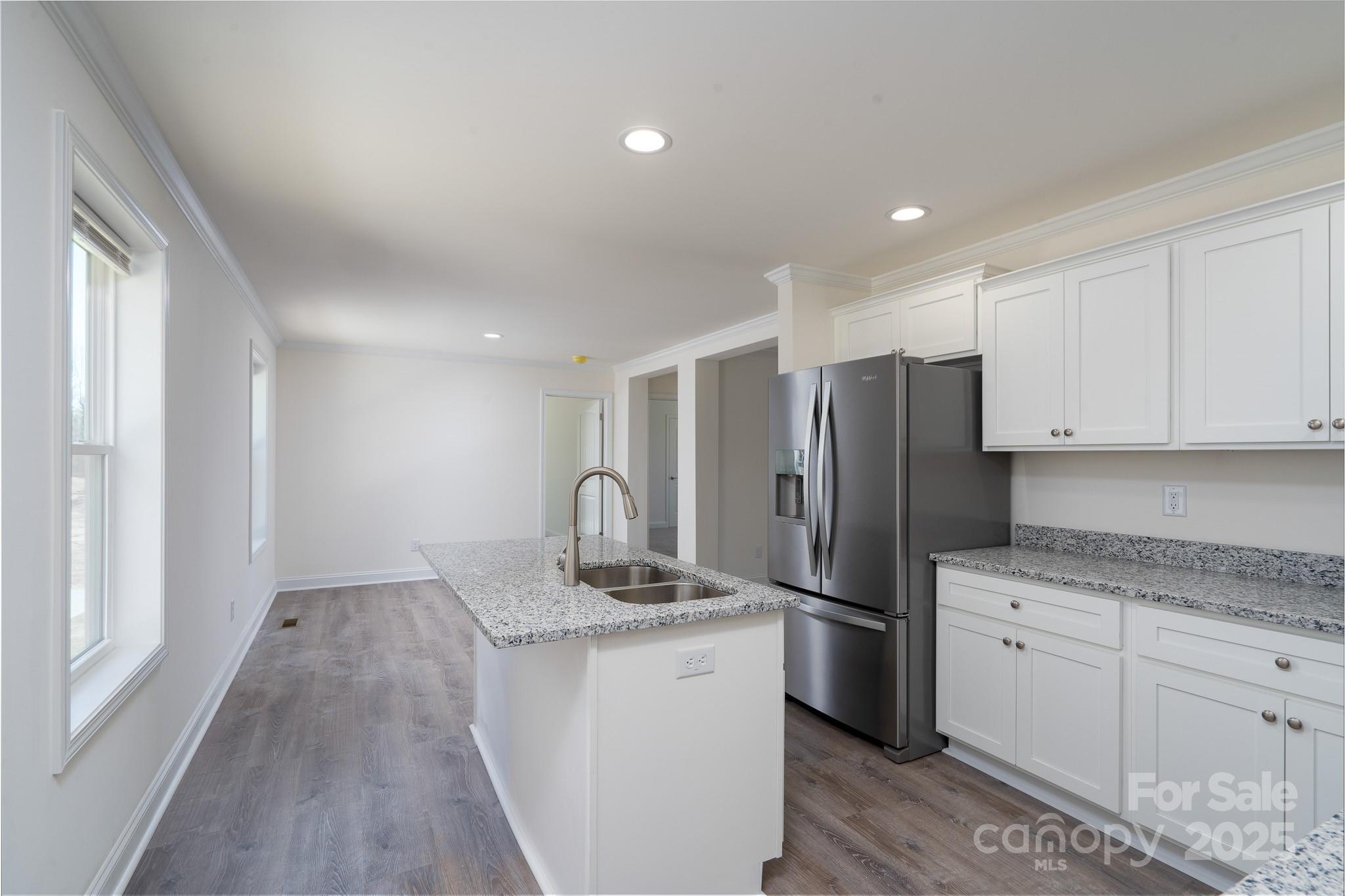 6205 Faith Road Salisbury, NC 28146 - Photo 13 of 33 a kitchen with a refrigerator sink and cabinets