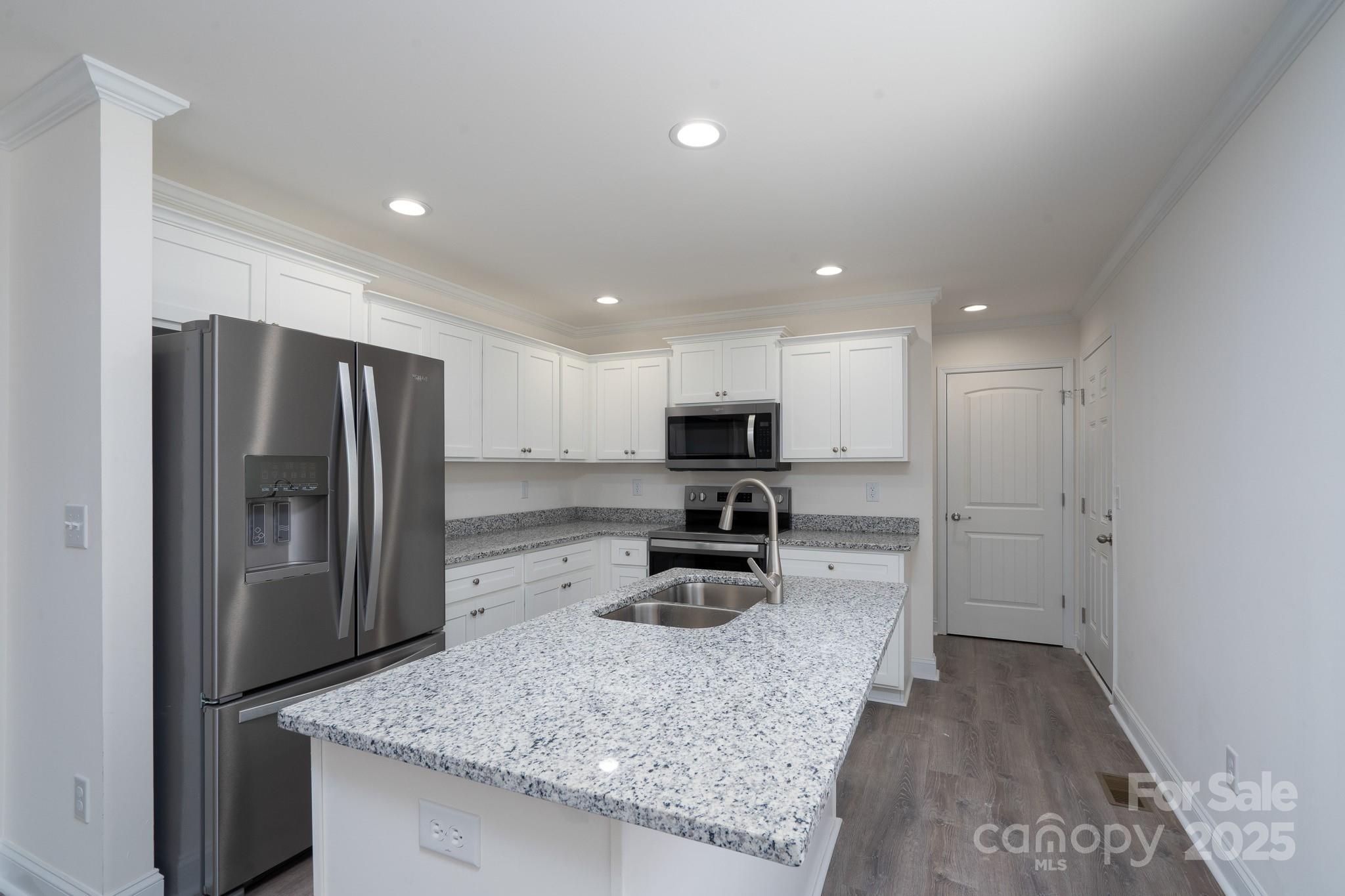 6205 Faith Road Salisbury, NC 28146 - Photo 14 of 33 a kitchen with sink refrigerator and microwave