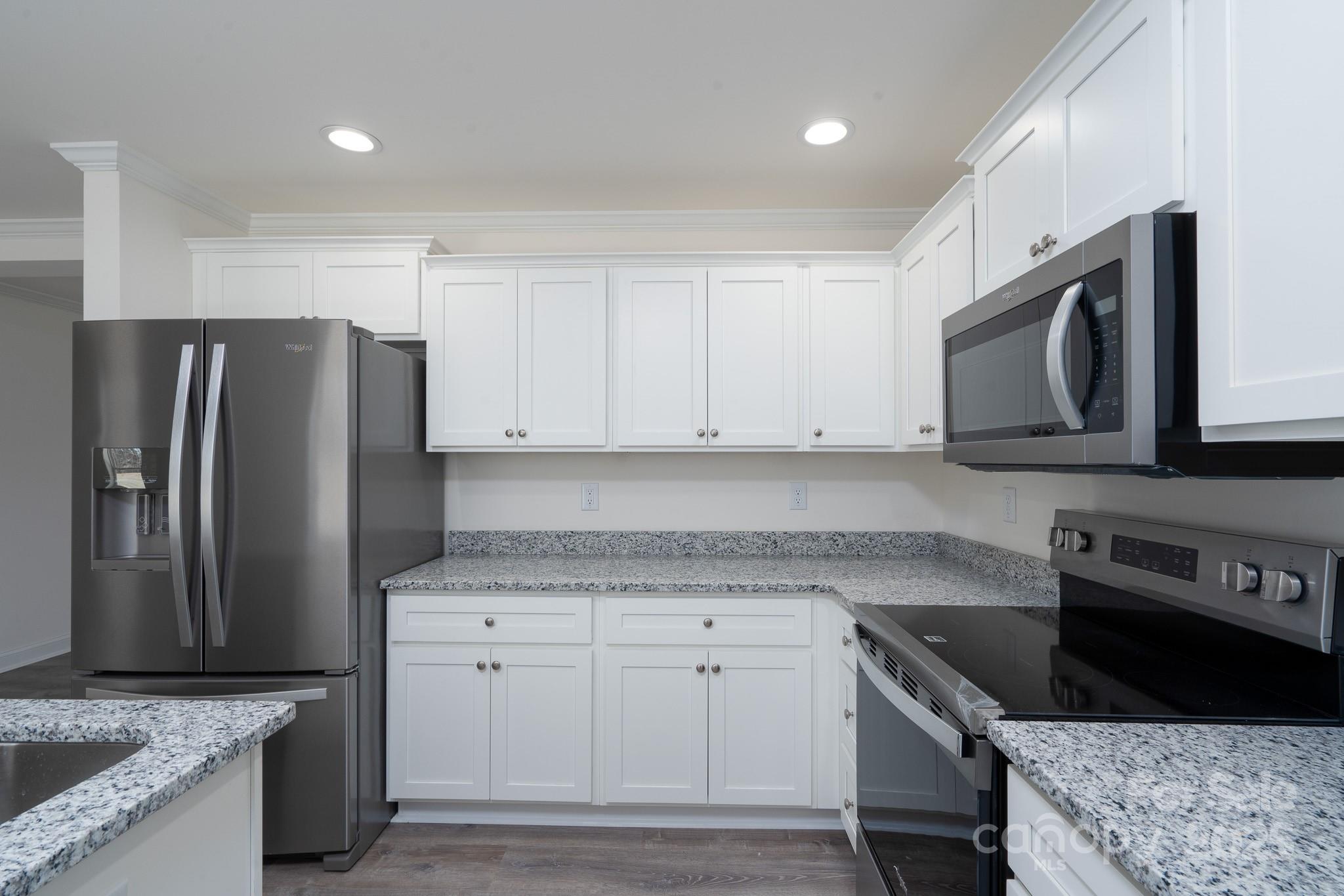 6205 Faith Road Salisbury, NC 28146 - Photo 15 of 33 a kitchen with granite countertop a sink stove and refrigerator