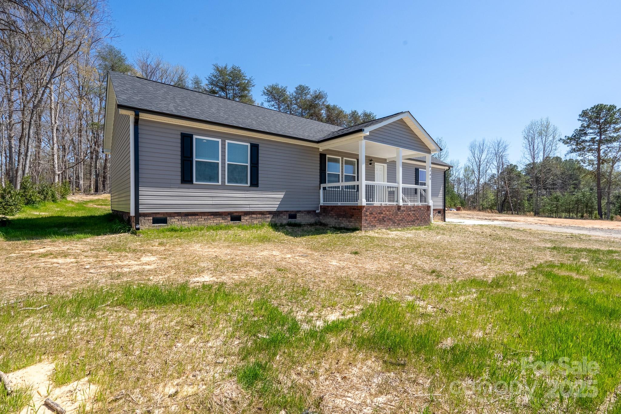 6205 Faith Road Salisbury, NC 28146 - Photo 2 of 33 a house view with a garden space