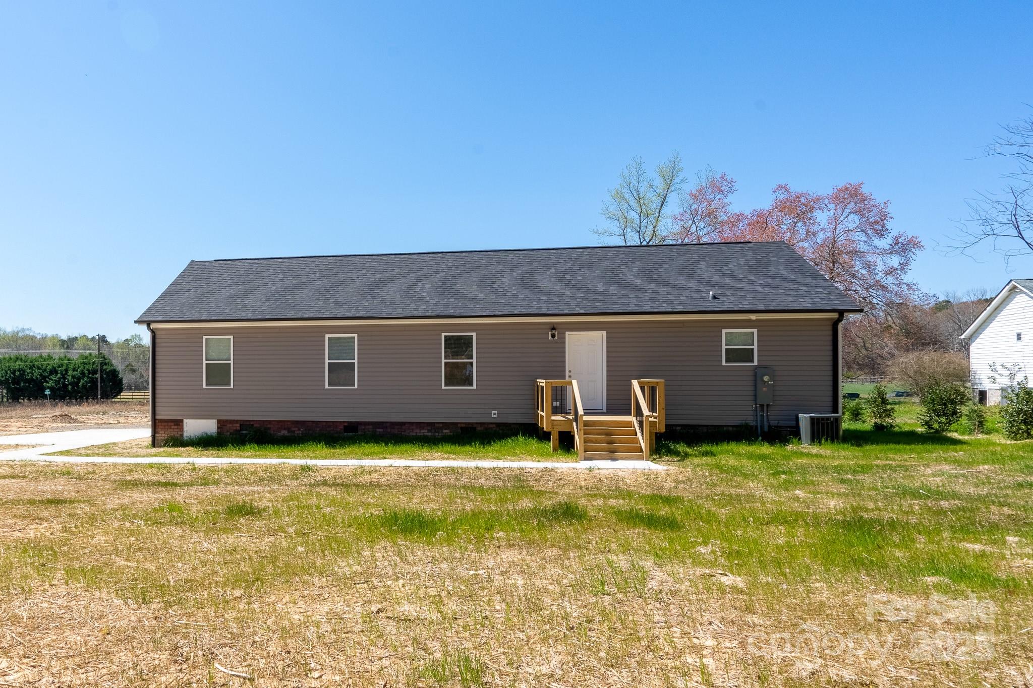 6205 Faith Road Salisbury, NC 28146 - Photo 30 of 33 a backyard of a house with yard and outdoor seating
