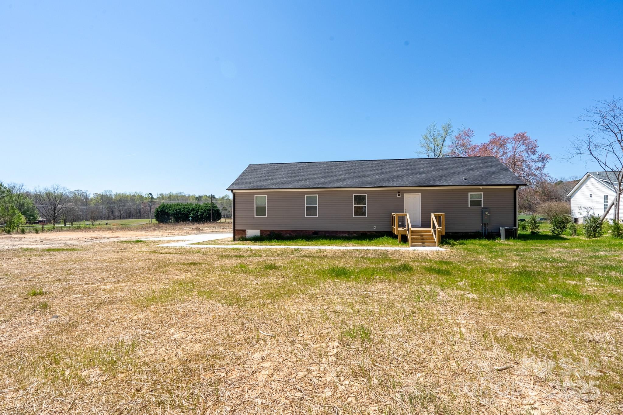6205 Faith Road Salisbury, NC 28146 - Photo 31 of 33 a view of a house with a swimming pool and a yard