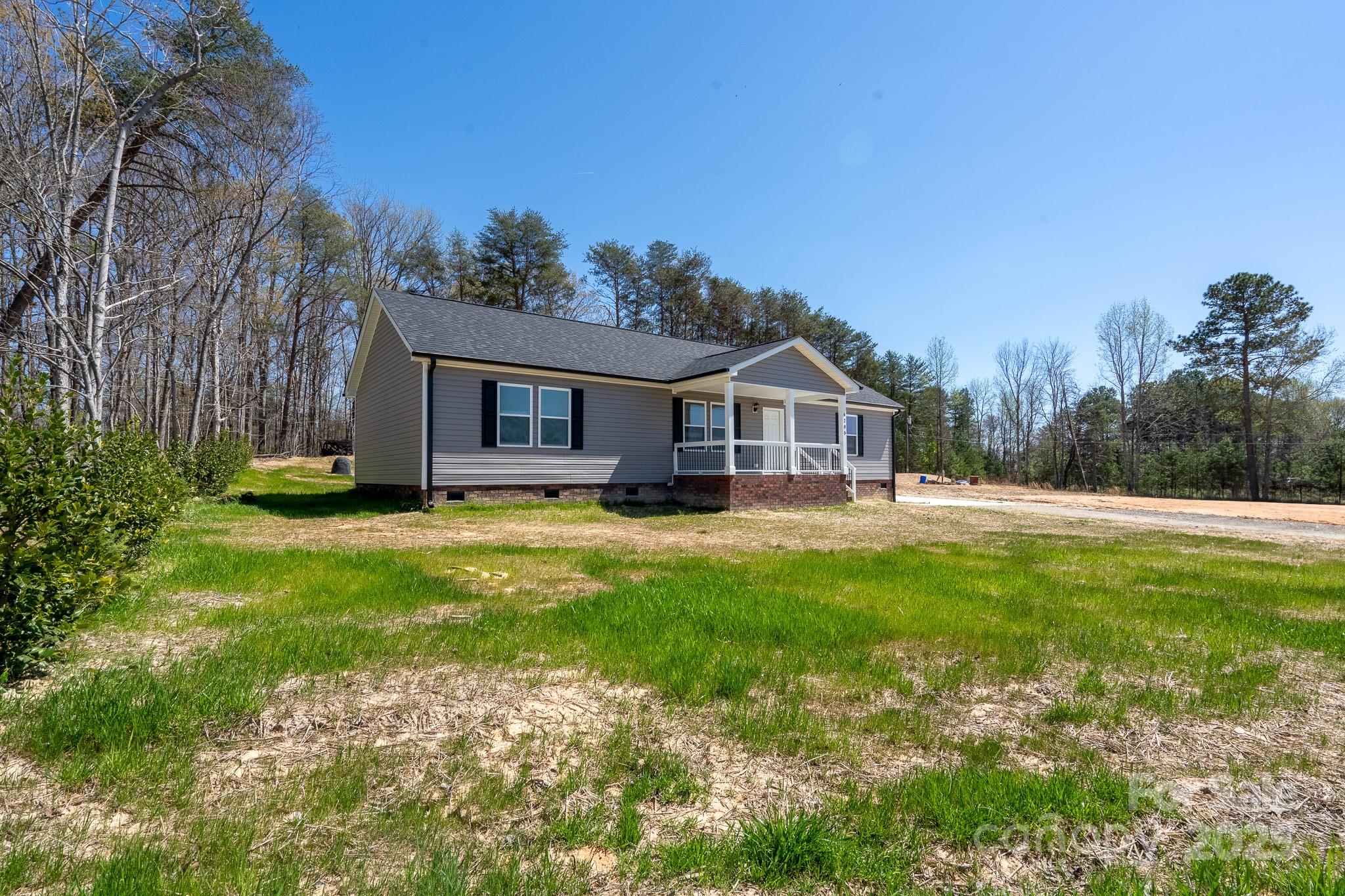 6205 Faith Road Salisbury, NC 28146 - Photo 4 of 33 a front view of a house with garden
