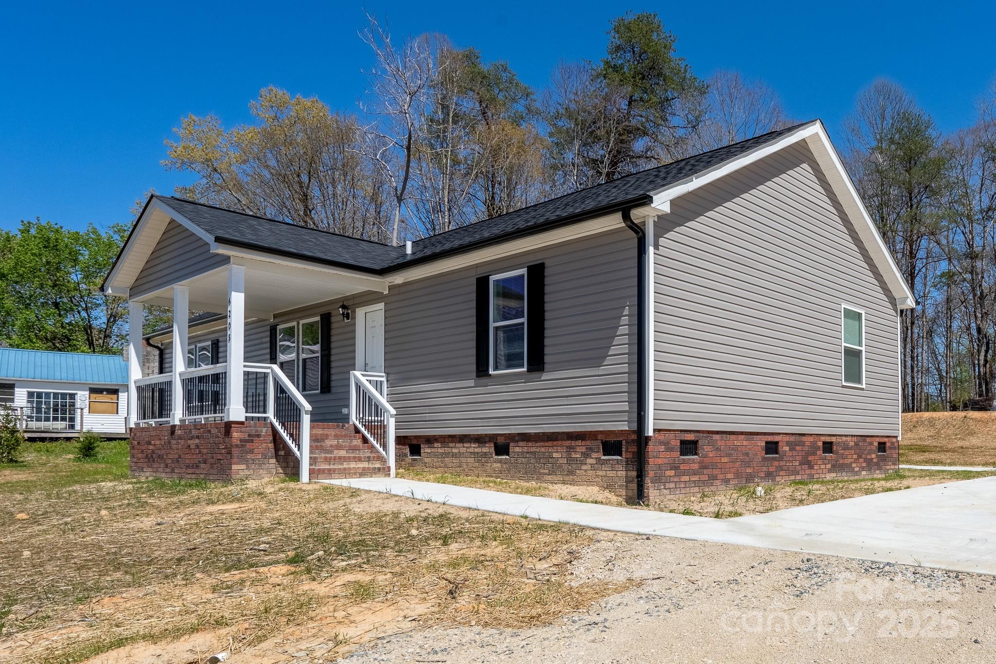 6205 Faith Road Salisbury, NC 28146 - Photo 5 of 33 a front view of a house with garden