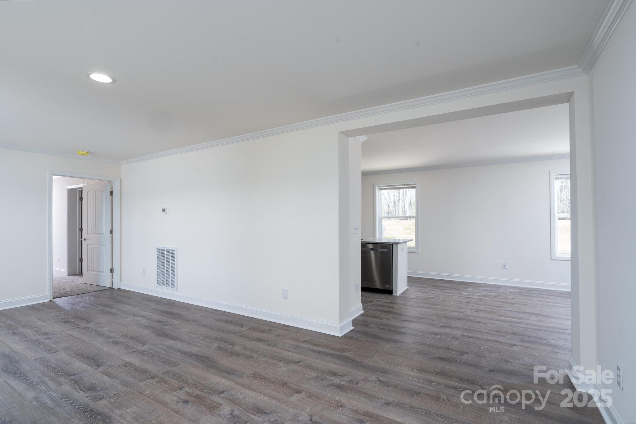 6205 Faith Road Salisbury, NC 28146 - Photo 10 of 33 a view of an empty room with wooden floor and a window