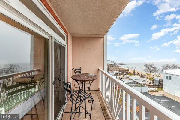 a balcony with wooden floor and city view